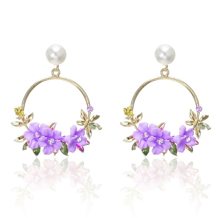 Elegant gold earrings adorned with flowers and pearls