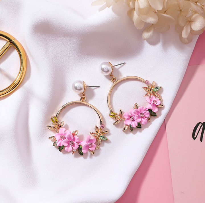 Elegant gold earrings adorned with flowers and pearls