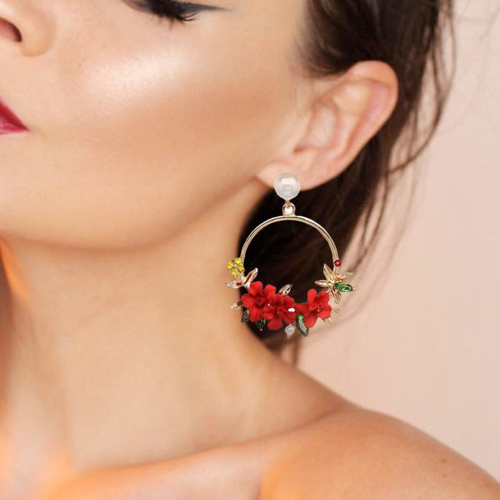 Elegant gold earrings adorned with flowers and pearls