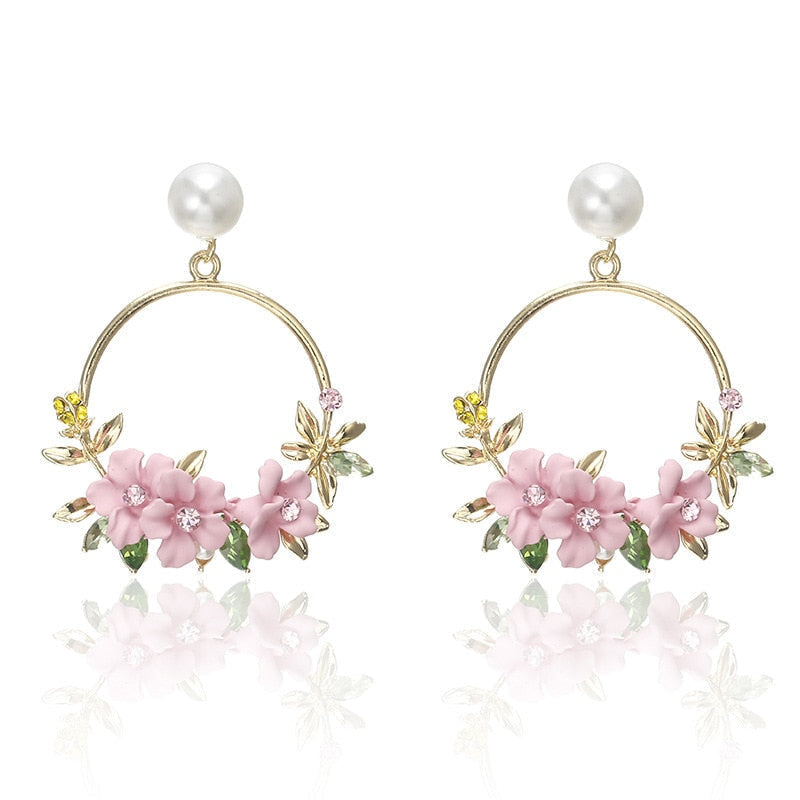 Elegant gold earrings adorned with flowers and pearls