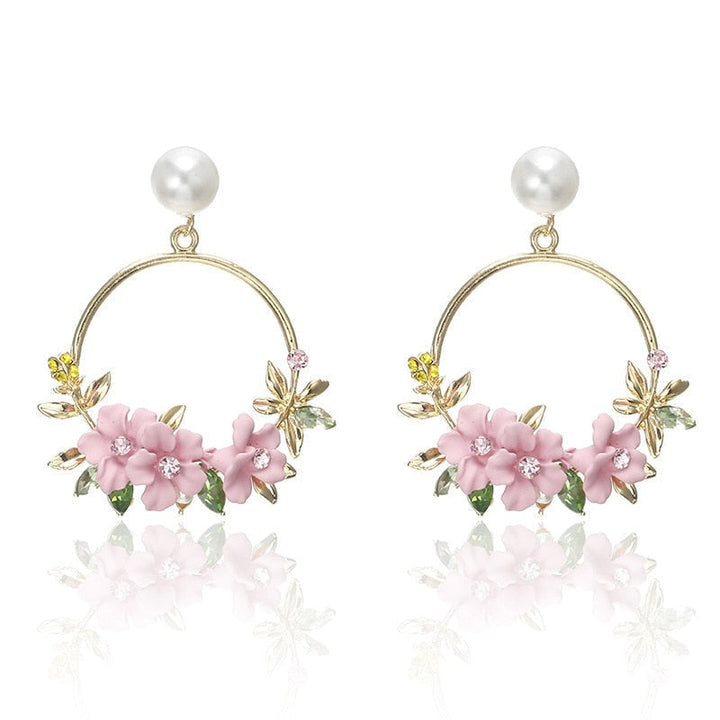 Elegant gold earrings adorned with flowers and pearls